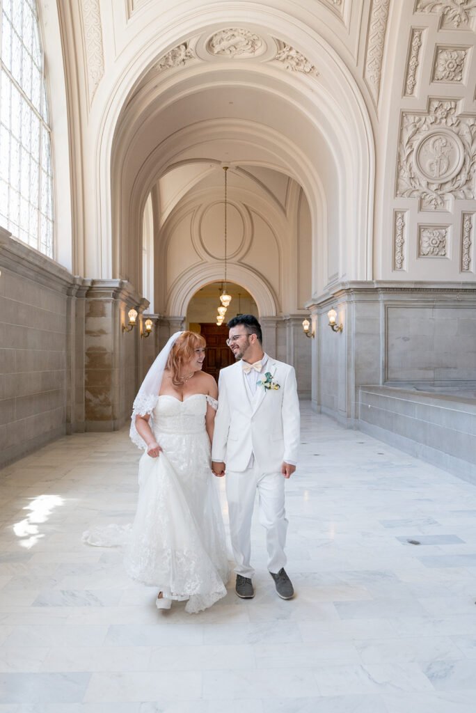Bride and groom smile at each other.